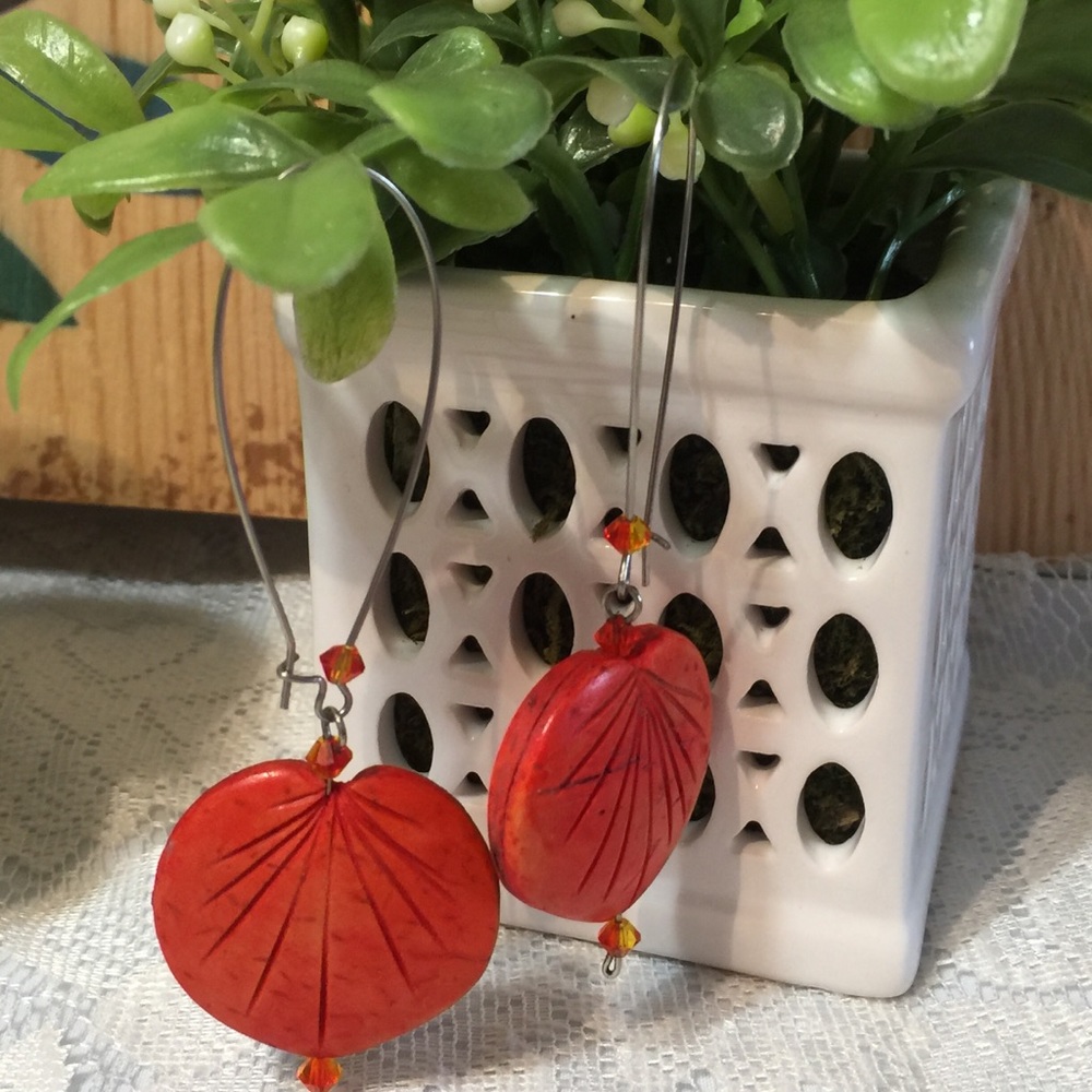 Unique set of dangle orange career earrings.